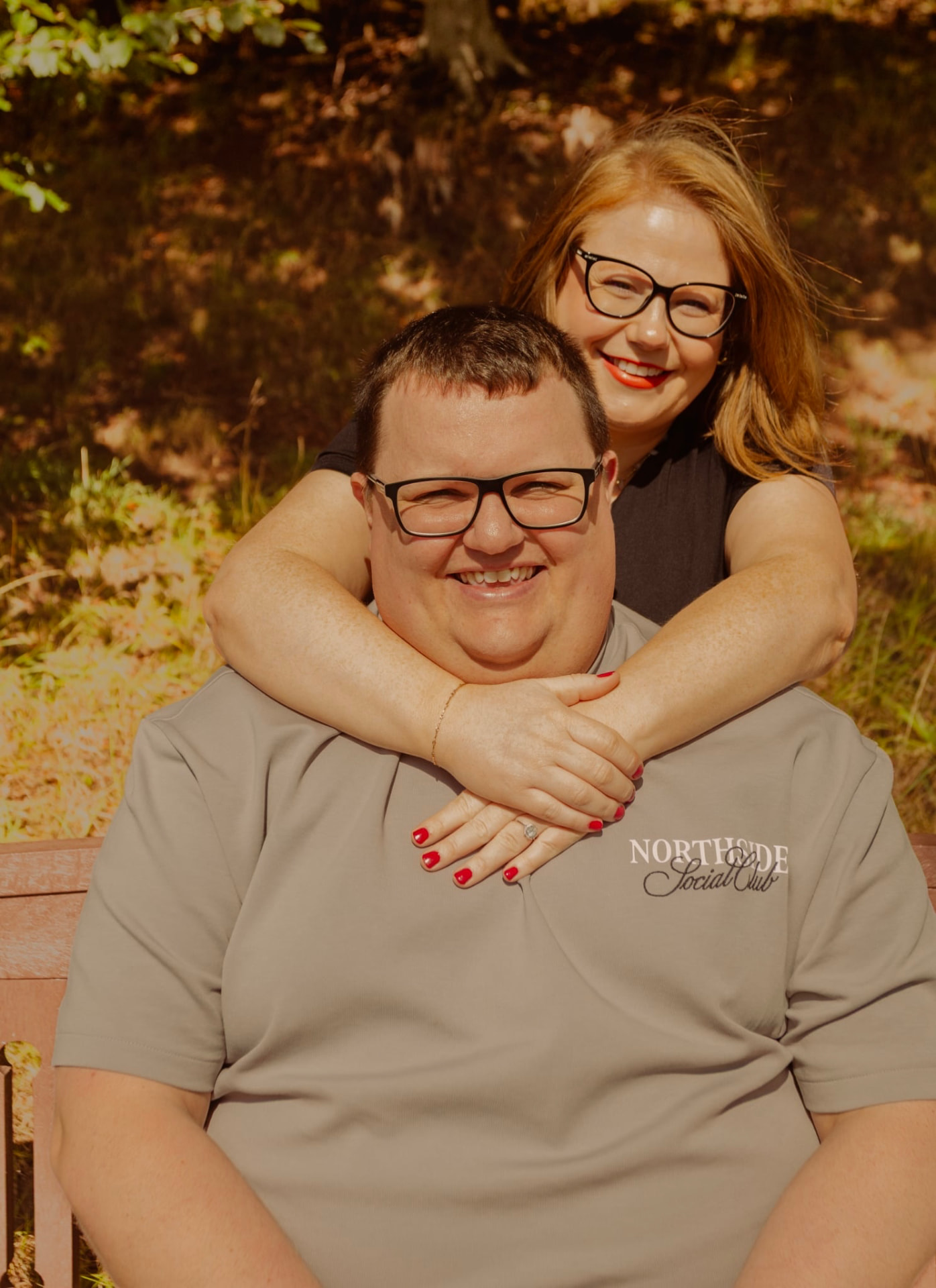 Couple laughing together on a park bench
